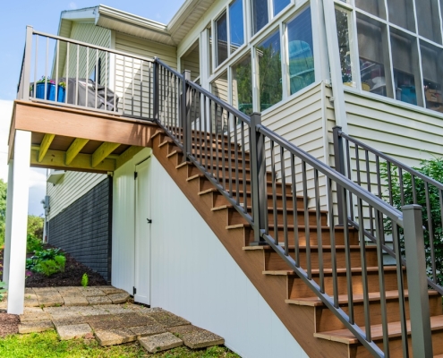 Rear view of a Grottes home with a new back deck.